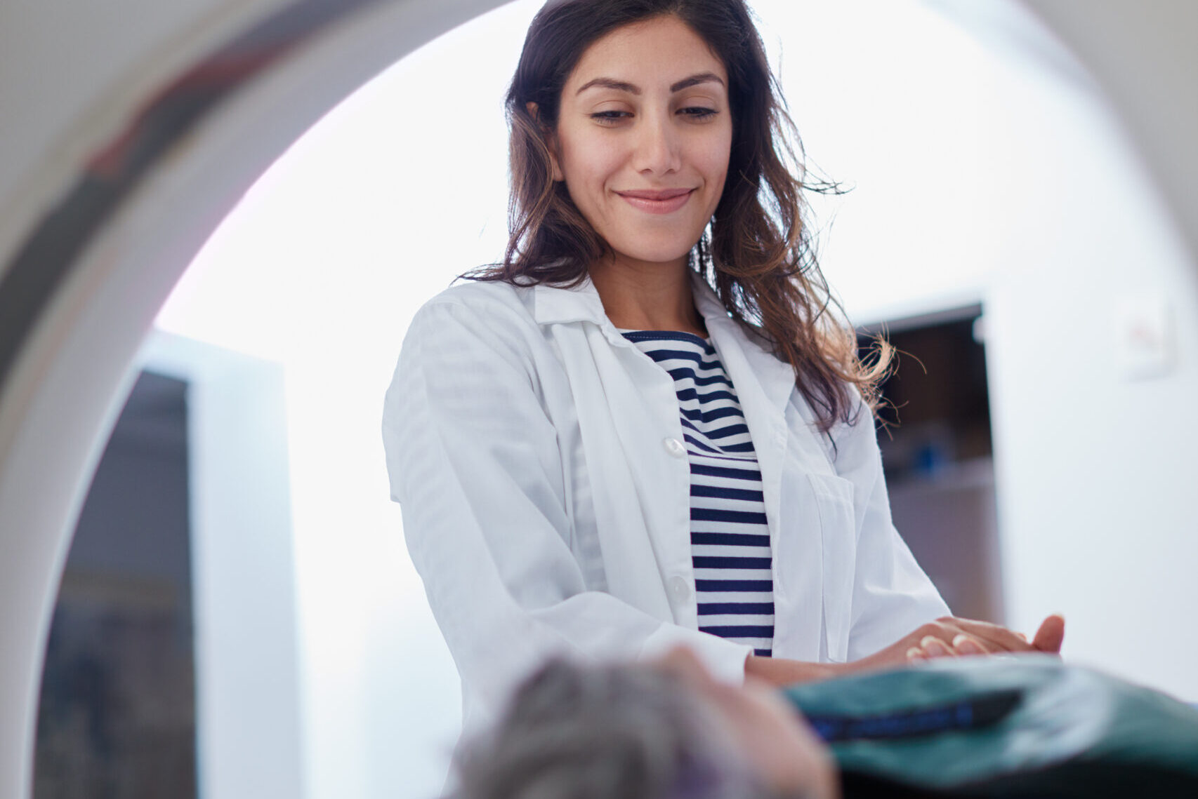 Shot of a mature woman being comforted by a doctor before MRI scan.