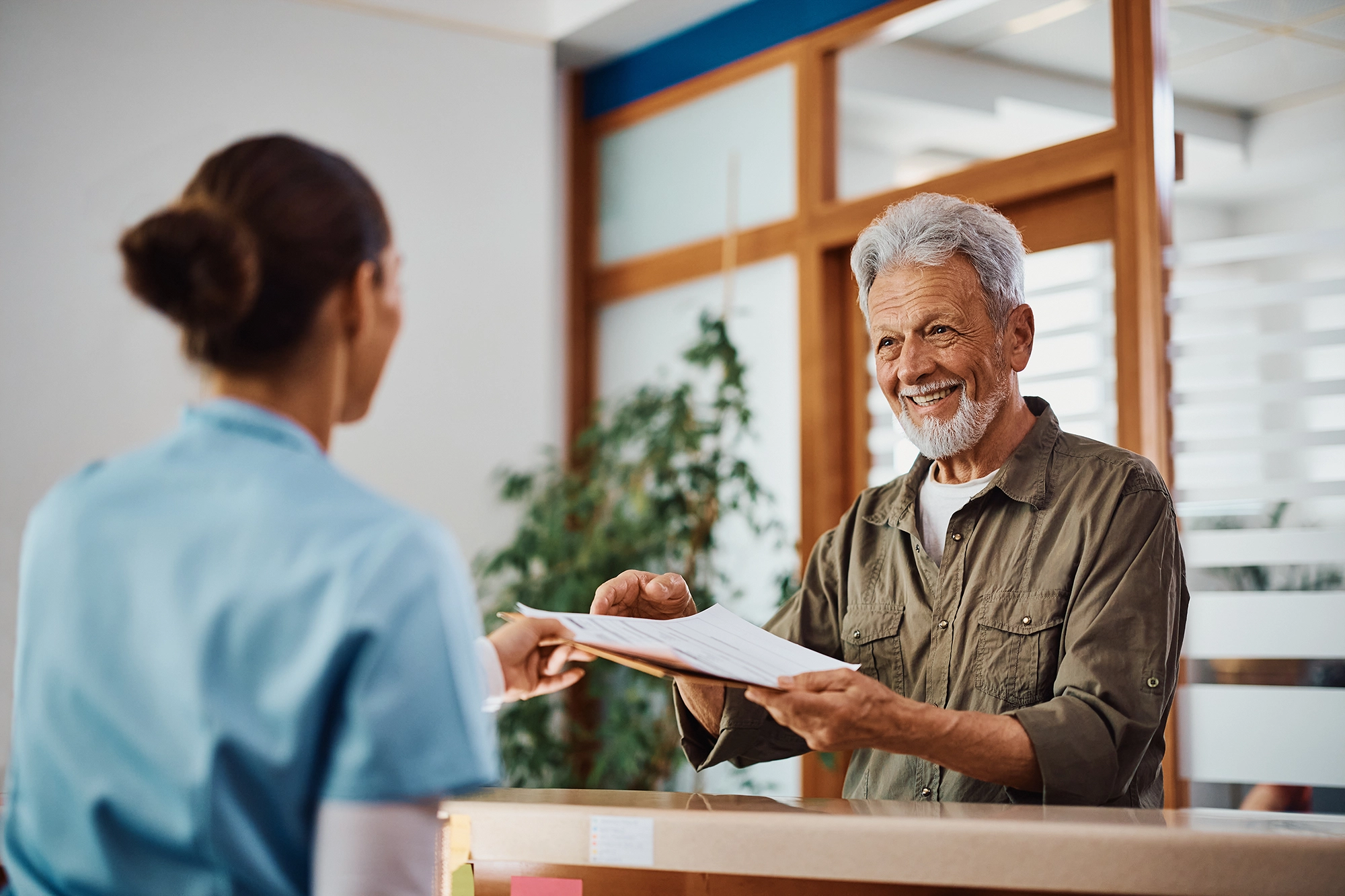 Man checking in with paperwork for diagnostic imaging appointment Gateway Diagnostic Imaging 
