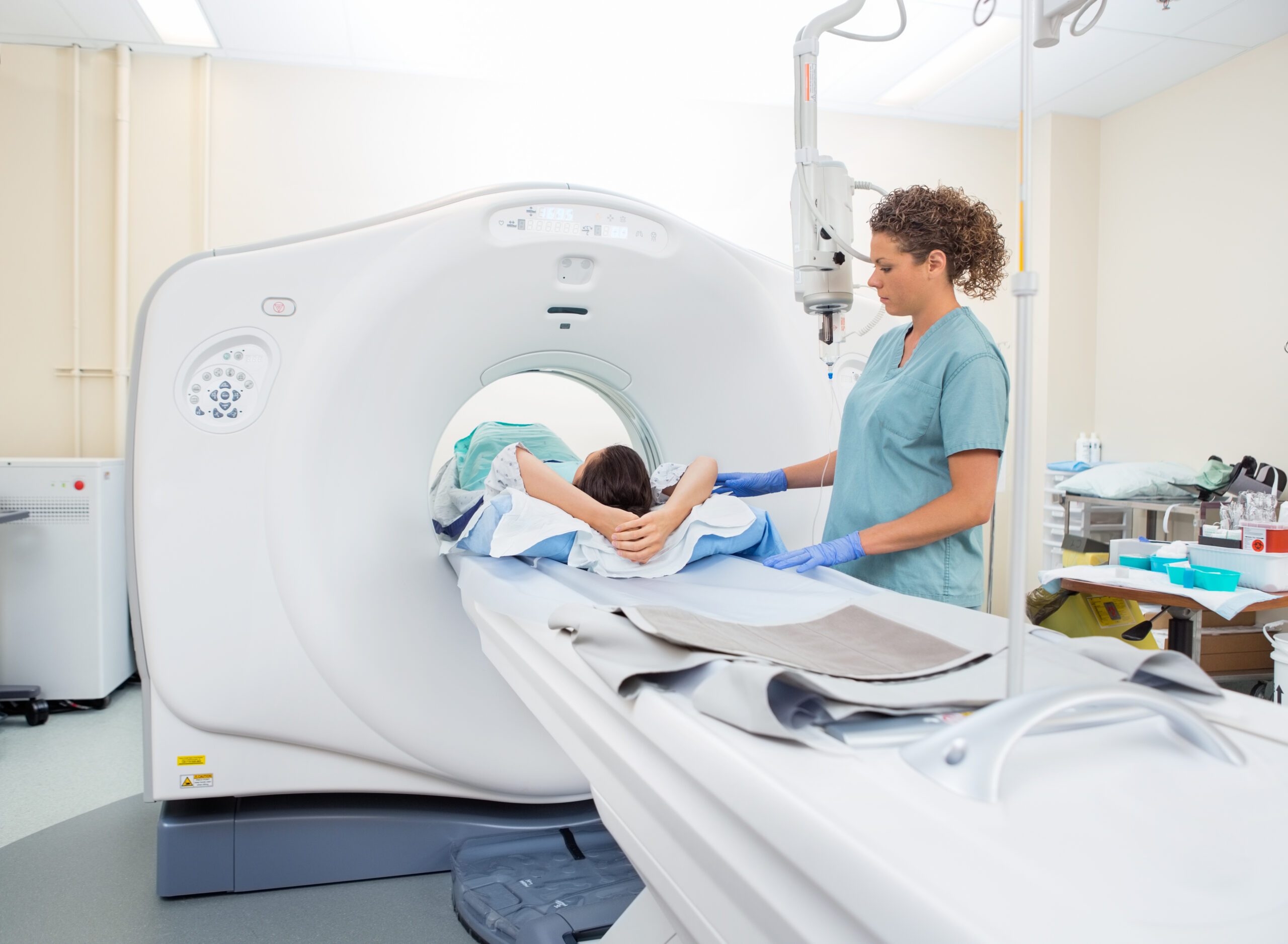 A nurse prepares a patient for an abdominal CT scan